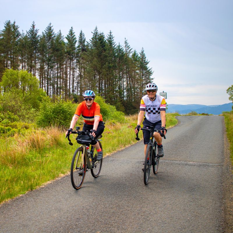 Two cyclists riding in Scotland on a cycling tour